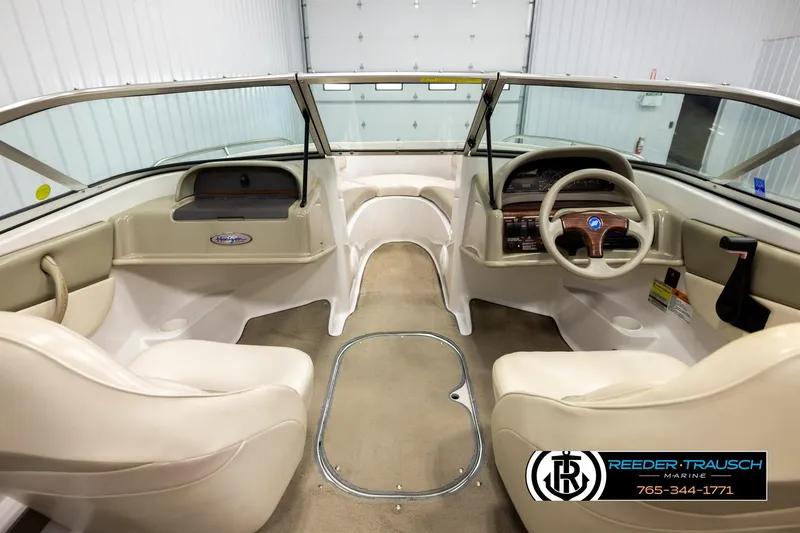 Slide: The Image of 1999 Four Winns 180 Horizon boat interior with beige seating and dashboard. - 13
