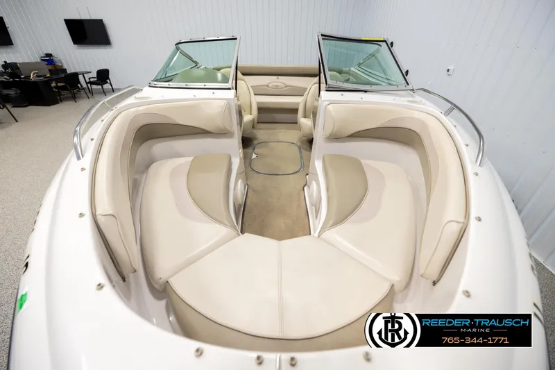 Slide: The Image of 1999 Four Winns 180 Horizon boat interior with beige seating in showroom. - 17
