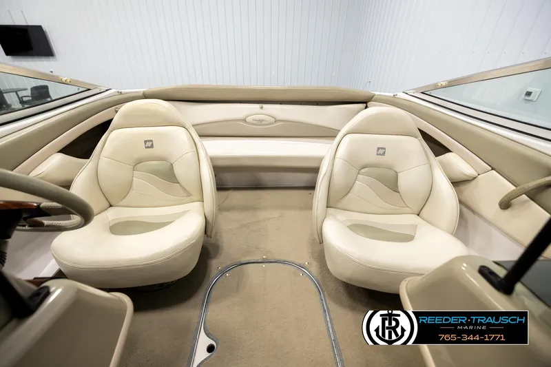 Slide: The Image of Interior of a 1999 Four Winns 180 Horizon boat with beige seating and carpet. - 18