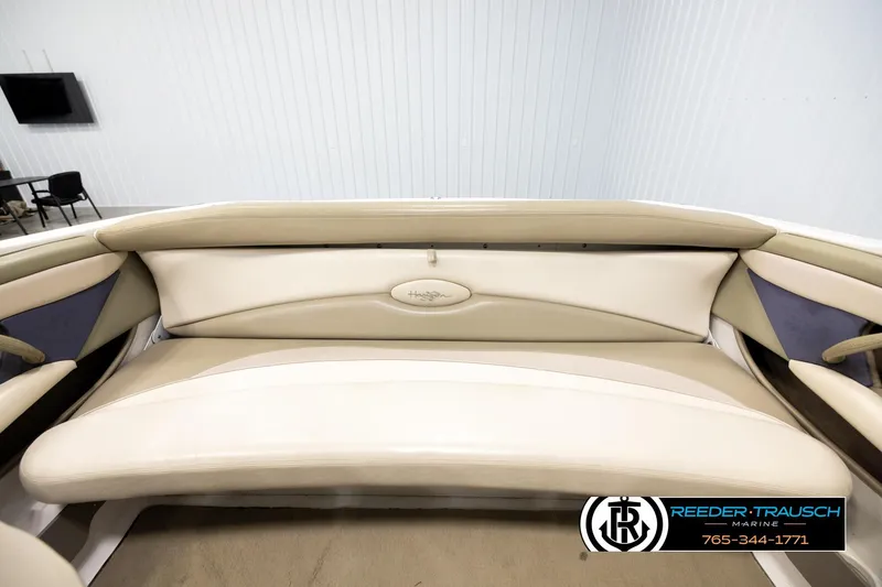 Slide: The Image of 1999 Four Winns 180 Horizon boat interior with beige seating and logo detail. - 19