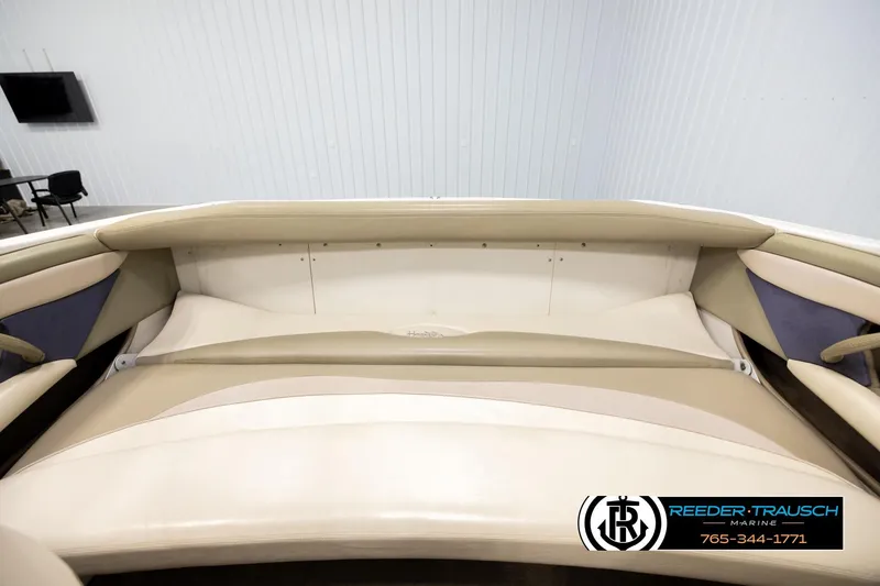 Slide: The Image of 1999 Four Winns 180 Horizon boat interior with beige seating in showroom. - 20