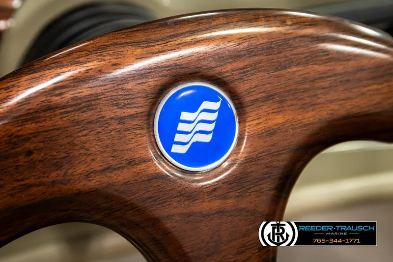Slide: The Image of Close-up of 1999 Four Winns 180 Horizon steering wheel with logo and wood finish. - 23