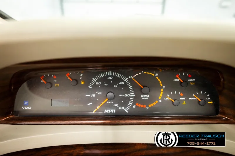 Slide: The Image of Dashboard of a 1999 Four Winns 180 Horizon boat with various gauges and indicators. - 25