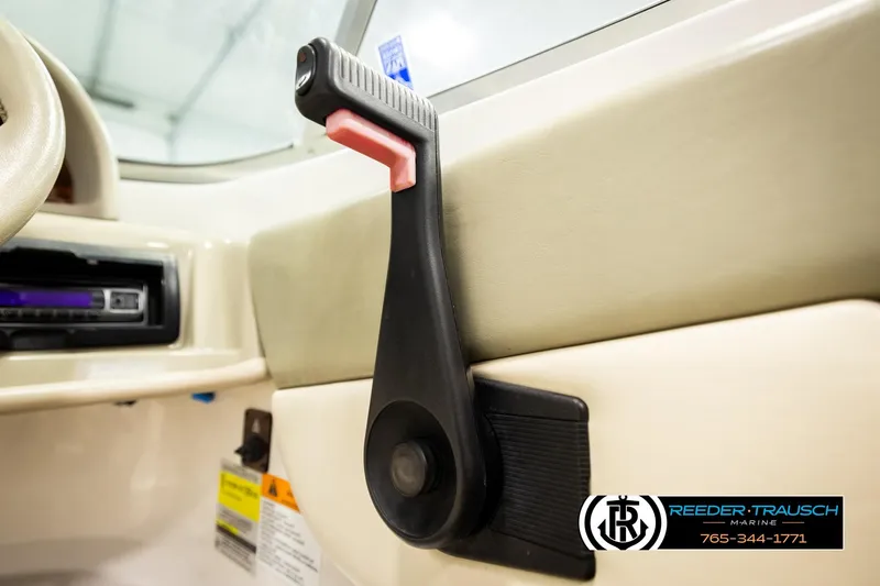 Slide: The Image of 1999 Four Winns 180 Horizon interior with manual window crank and dashboard details. - 27