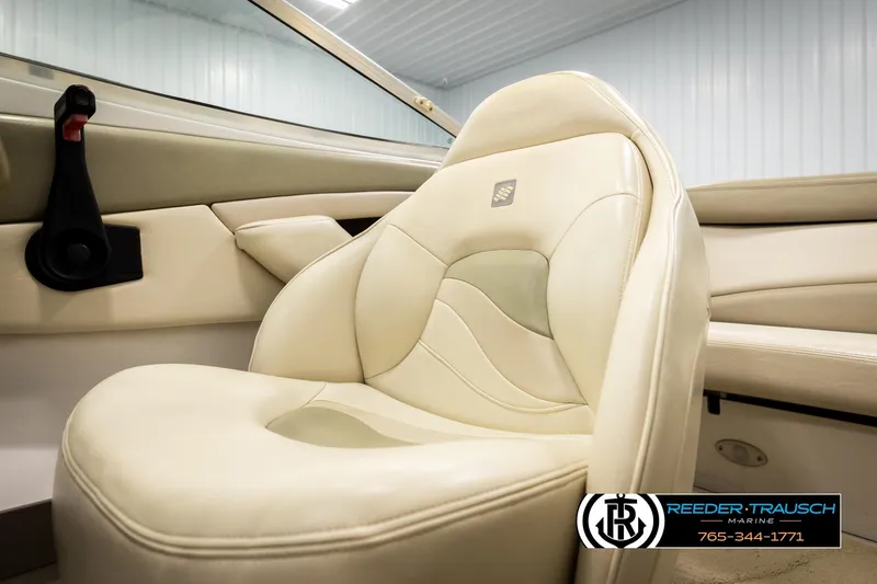 Slide: The Image of 1999 Four Winns 180 Horizon boat interior with beige leather seating. - 28