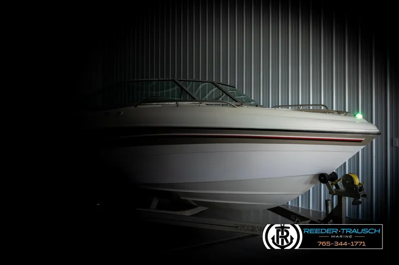 Slide: The Image of 1999 Four Winns 180 Horizon boat in dimly lit storage, side view. - 3