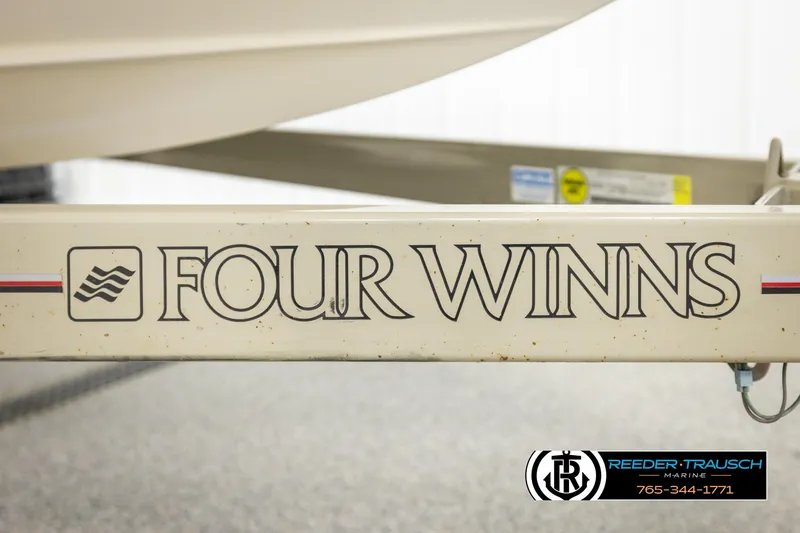 Slide: The Image of 1999 Four Winns 180 Horizon boat trailer with logo and Reeder-Trausch Marine branding. - 39