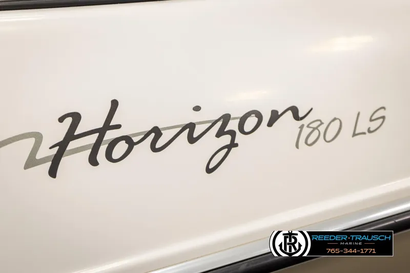 Slide: The Image of 1999 Four Winns 180 Horizon boat logo on white surface, Reeder-Trausch Marine branding. - 40