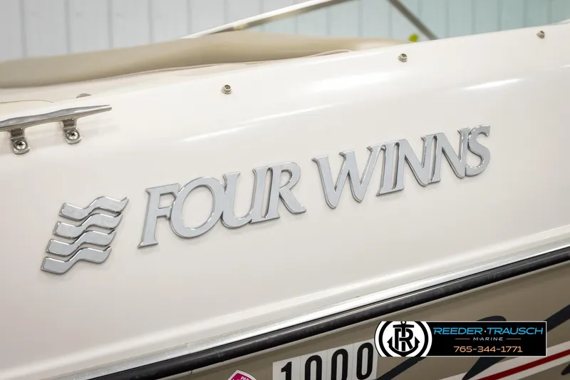Slide: The Image of 1999 Four Winns 180 Horizon boat with logo detail, Reeder-Trausch Marine branding. - 41