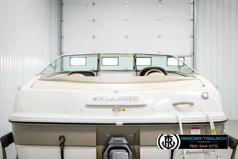 Slide: The Image of 1999 Four Winns 180 Horizon boat in a garage, rear view. - 6