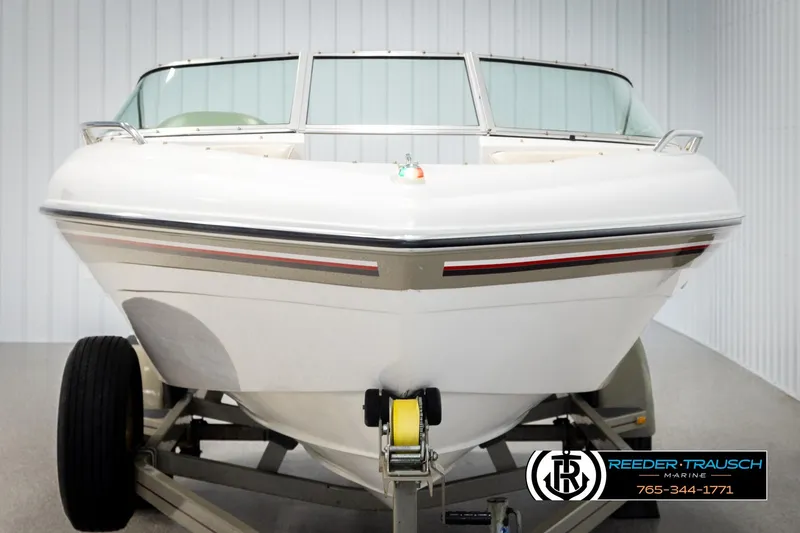 Slide: The Image of 1999 Four Winns 180 Horizon boat on trailer, front view in showroom. - 7