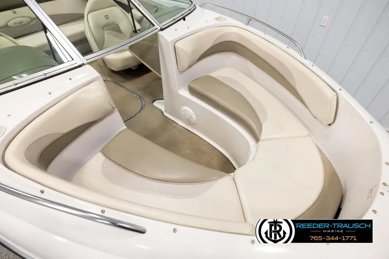 Slide: The Image of 1999 Four Winns 180 Horizon boat interior with beige seating and windshield. - 8