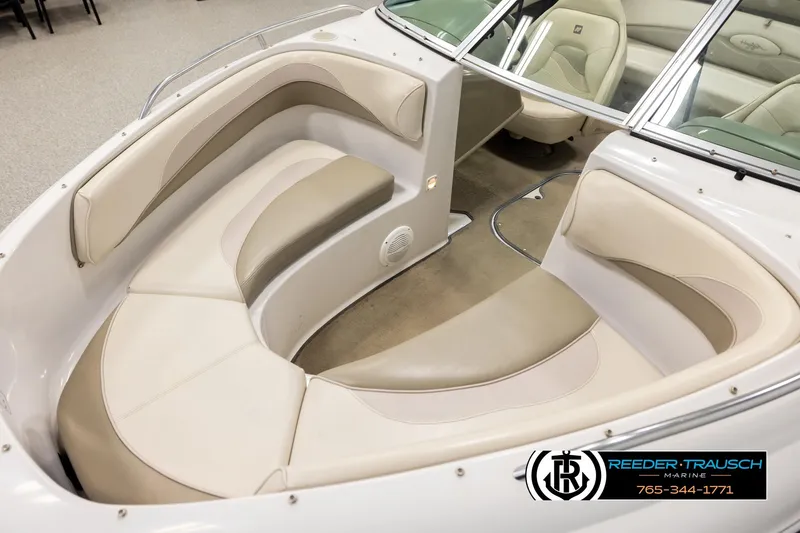 Slide: The Image of 1999 Four Winns 180 Horizon boat interior with beige seating and windshield. - 9