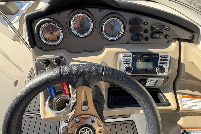 Slide: The Image of Dashboard of 2014 Yamaha Boats 242 Limited S with steering wheel and controls. - 10