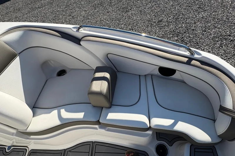 Slide: The Image of 2014 Yamaha Boats 242 Limited S interior seating with white and gray upholstery. - 14