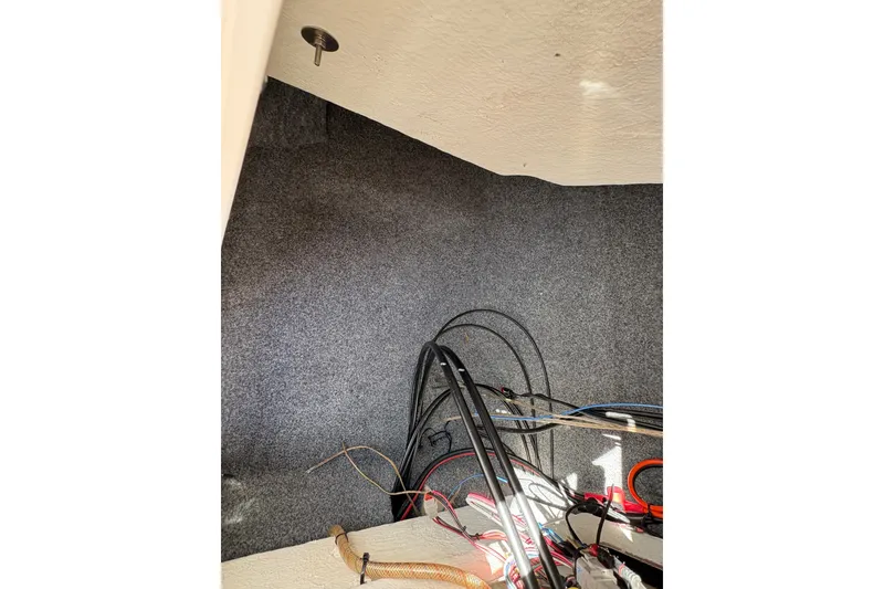 Slide: The Image of Interior wiring of a 2014 Yamaha Boats 242 Limited S, showing cables and carpeted walls. - 17