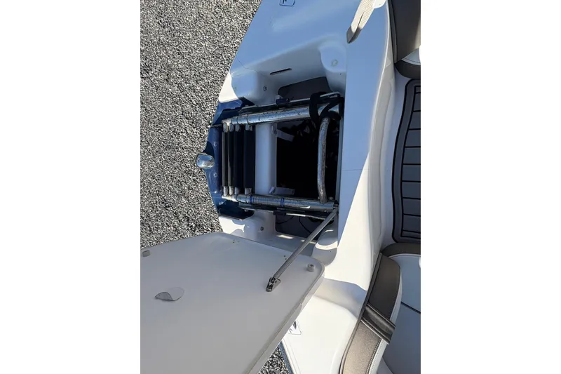 Slide: The Image of Open storage compartment on 2014 Yamaha Boats 242 Limited S, showing interior details. - 18