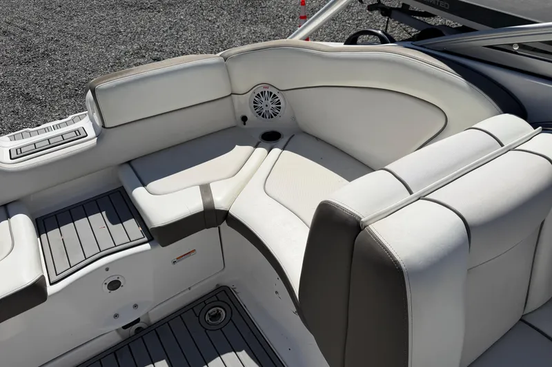 Slide: The Image of 2014 Yamaha Boats 242 Limited S interior seating with white upholstery and speaker. - 20