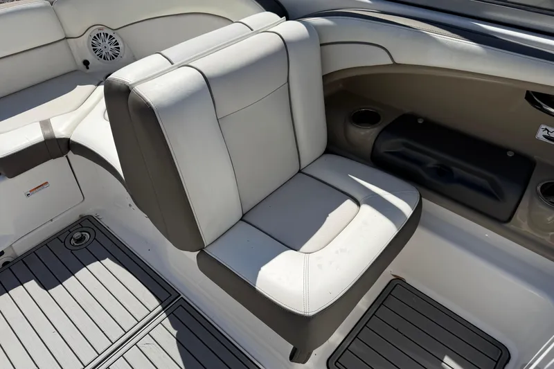 Slide: The Image of 2014 Yamaha Boats 242 Limited S interior seating with gray upholstery and cup holders. - 21