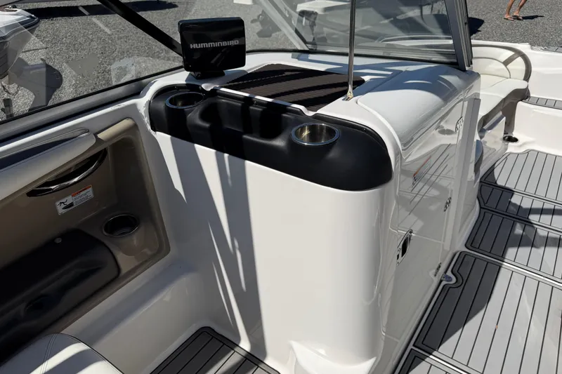 Slide: The Image of 2014 Yamaha Boats 242 Limited S interior with cup holders and Humminbird device. - 22