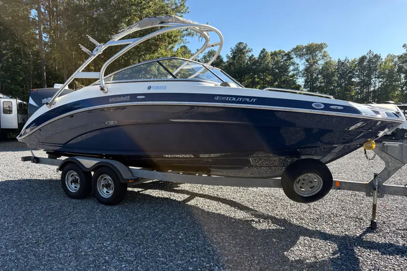 Slide: The Image of 2014 Yamaha Boats 242 Limited S on trailer, parked outdoors. - 5
