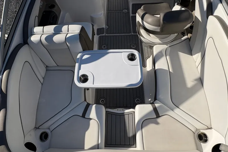 Slide: The Image of 2014 Yamaha Boats 242 Limited S interior with seating and table setup. - 8