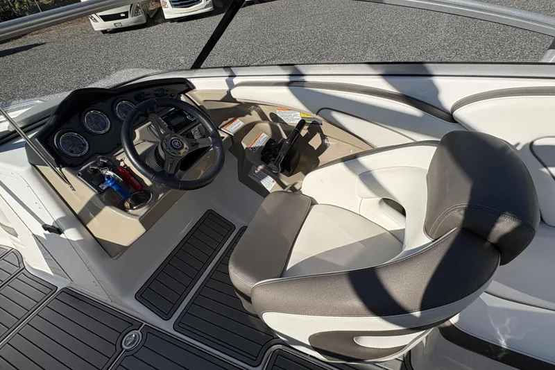 Slide: The Image of 2014 Yamaha Boats 242 Limited S cockpit with steering wheel and controls. - 9