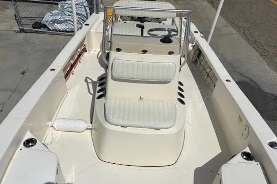 Slide: The Image of 2014 BlackJack 224 Bay boat interior with white seating and steering console. - 11