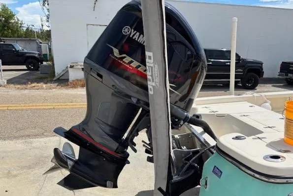 Slide: The Image of 2014 BlackJack 224 Bay boat with Yamaha outboard motor, parked outdoors. - 12