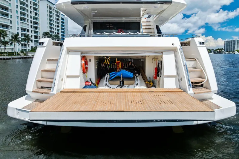 Slide: The Image of 2018 Ferretti Yachts 850 Motoryacht with open garage and water sports equipment. - 12