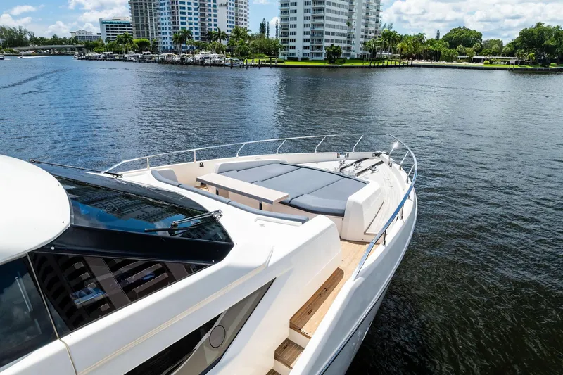 Slide: The Image of 2018 Ferretti Yachts 850 Motoryacht on water, with luxurious deck and scenic city backdrop. - 13