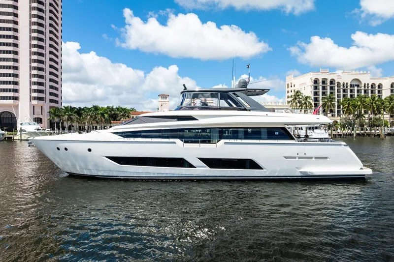 Slide: The Image of 2018 Ferretti Yachts 850 Motoryacht docked near luxury waterfront buildings. - 2
