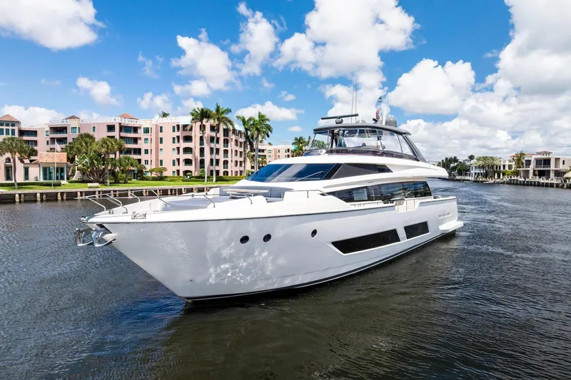 Slide: The Image of 2018 Ferretti Yachts 850 Motoryacht cruising on a scenic waterway with luxury buildings. - 3