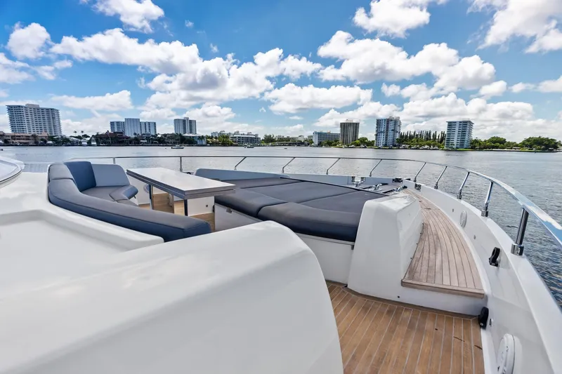 Slide: The Image of Luxurious 2018 Ferretti Yachts 850 Motoryacht deck with seating, overlooking city skyline and water. - 28