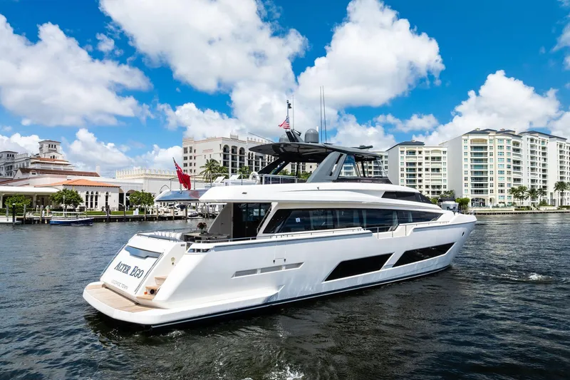 Slide: The Image of 2018 Ferretti Yachts 850 Motoryacht cruising near waterfront buildings under blue sky. - 4
