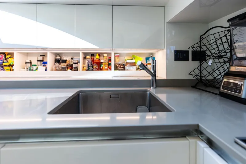 Slide: The Image of Modern kitchen in 2018 Ferretti Yachts 850 Motoryacht with sleek countertops and organized shelves. - 50