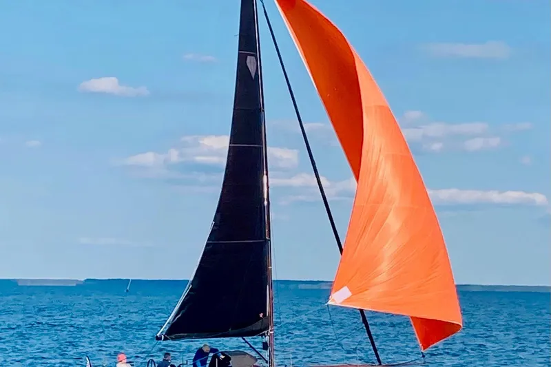 Slide: The Image of Saffier 33 Life sailboat with orange sail on open water, 2022 model. - 24