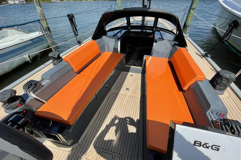 Slide: The Image of 2022 Saffier 33 Life sailboat with orange seating, docked by the water. - 9