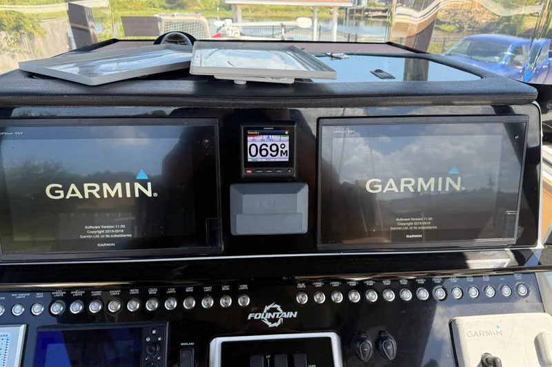 Slide: The Image of Close-up of 2019 Fountain 38 CC LS boat dashboard displaying engine hours and maintenance data. - 19
