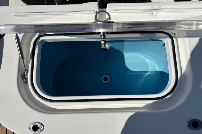 Slide: The Image of Open hatch on 2019 Fountain 38 CC LS boat, revealing interior compartment. - 2