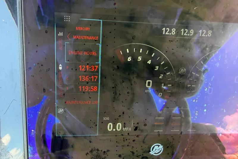 Slide: The Image of 2019 Fountain 38 CC LS boat on trailer, black hull, triple engines, outdoor setting. - 20