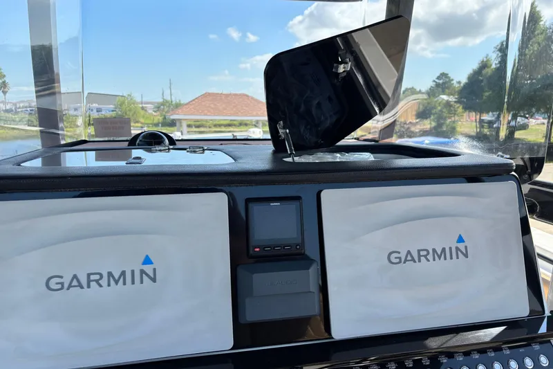 Slide: The Image of 2019 Fountain 38 CC LS boat with triple Mercury outboard engines and open storage compartments. - 4