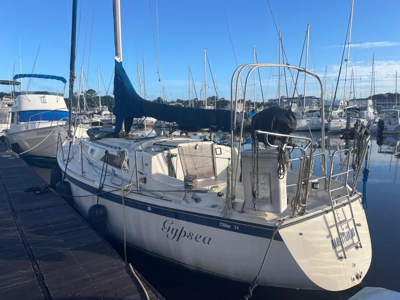 The Image of 1982 O'Day 34 sailboat docked in a marina, clear blue sky. - 0