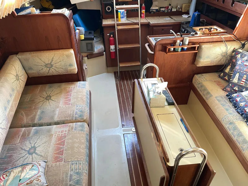 Slide: The Image of Interior of 1982 O'Day 34 sailboat with cozy seating and wooden cabinetry. - 10