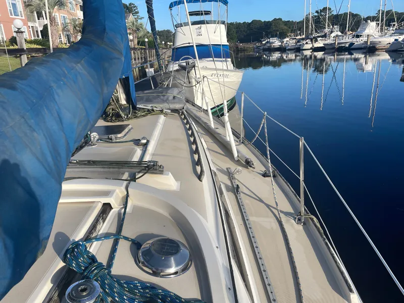 Slide: The Image of 1982 O'Day 34 sailboat docked in a marina with calm water reflections. - 2