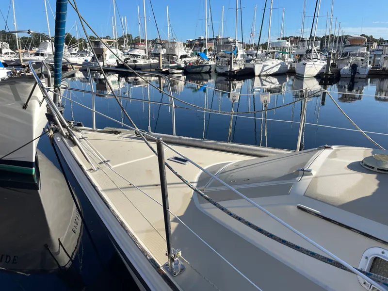 Slide: The Image of 1982 O'Day 34 sailboat docked in a marina with calm water reflections. - 3