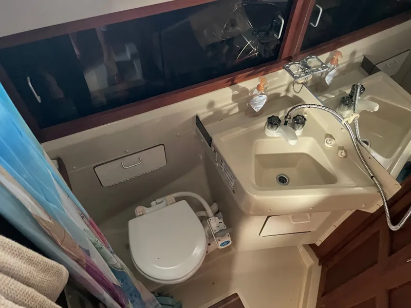 Slide: The Image of 1982 O'Day 34 yacht bathroom with sink, toilet, and shower area. - 8