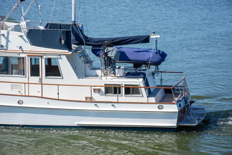 Slide: The Image of 1990 Grand Banks 36 Classic helm with wooden wheel and navigation instruments. - 10