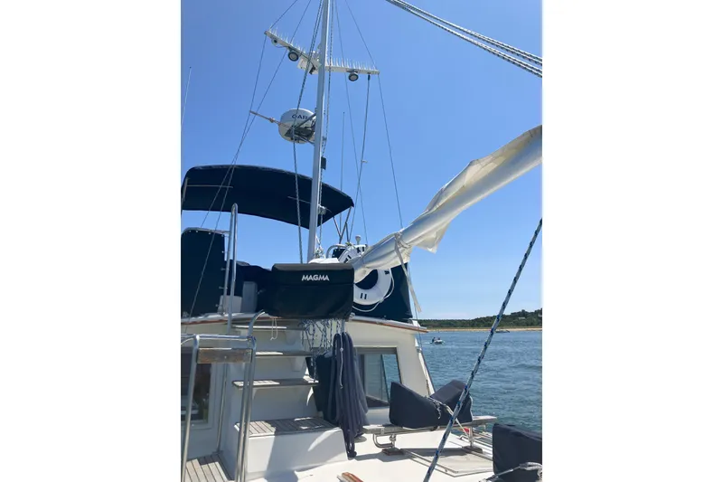 Slide: The Image of Interior of 1990 Grand Banks 36 Classic yacht with wooden stairs and cozy seating area. - 11