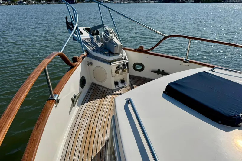 Slide: The Image of Cozy cabin interior of 1990 Grand Banks 36 Classic with plaid bedding and wooden storage. - 15